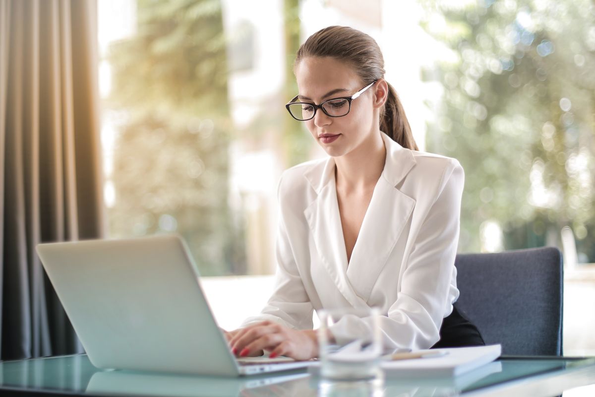 Canadian business owner reviewing benefits plan on a laptop