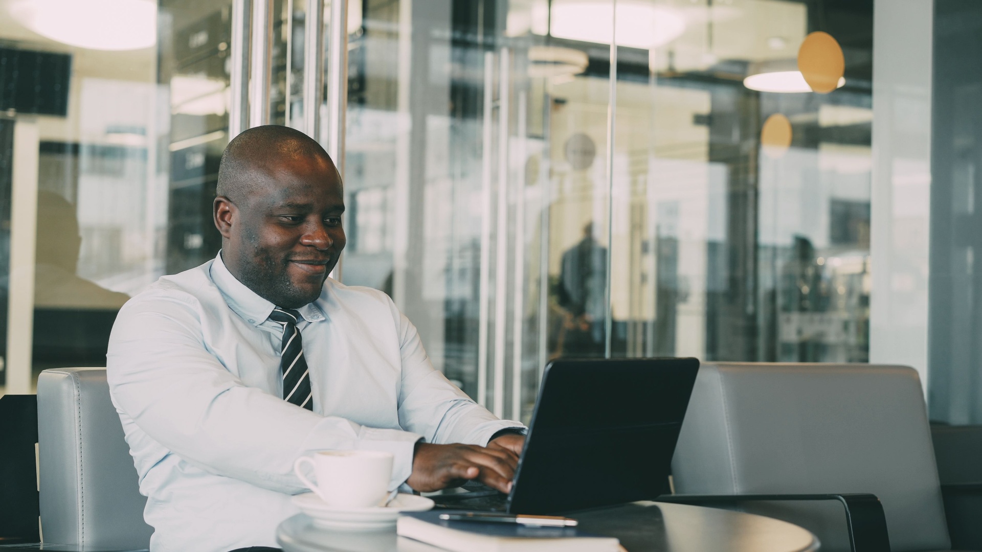 A professional working at a laptop in a bright modern workspace
