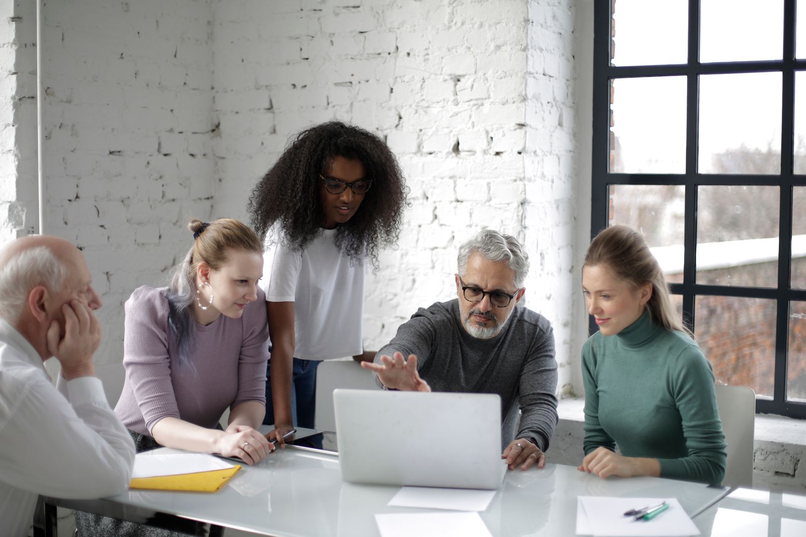 A small team talking through a plan together at an office table.